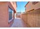 Side yard with concrete patio and brick wall for privacy at 8557 Nature Scene Dr, Las Vegas, NV 89139