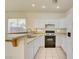 White kitchen features gas range and ample counter space at 8557 Nature Scene Dr, Las Vegas, NV 89139