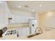 White kitchen with stainless steel appliances and breakfast bar at 8557 Nature Scene Dr, Las Vegas, NV 89139