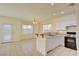 Bright kitchen with white cabinets, gas range, and breakfast bar at 8557 Nature Scene Dr, Las Vegas, NV 89139
