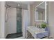 Modern bathroom featuring a walk-in shower with accent tiles and a stylish vanity with marble countertop at 8880 W Ann Rd, Las Vegas, NV 89149