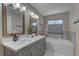 Bathroom with double vanity, a bathtub, tiled floors and backsplash, and natural light at 8880 W Ann Rd, Las Vegas, NV 89149