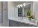 Bathroom featuring a gray vanity with white countertop, a large mirror, and modern lighting at 8880 W Ann Rd, Las Vegas, NV 89149