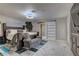 Primary bedroom with an accent wall, en-suite bathroom, and a large bed with stylish furnishings at 8880 W Ann Rd, Las Vegas, NV 89149