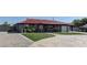 Charming gray home with a red tile roof, well-manicured lawn, and a circular driveway at 8880 W Ann Rd, Las Vegas, NV 89149