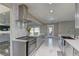 Modern kitchen features an island with gray cabinetry, stainless steel appliances, white countertop, and marble flooring at 8880 W Ann Rd, Las Vegas, NV 89149