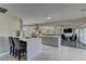Open-concept kitchen featuring an island with bar seating, stainless steel appliances, and marble flooring at 8880 W Ann Rd, Las Vegas, NV 89149