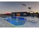 Beautiful backyard pool with diving board, complemented by modern pool house and landscaping at 8880 W Ann Rd, Las Vegas, NV 89149