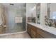 Spa-like bathroom featuring double sinks, a walk-in shower, and mosaic accents at 1120 Casady Hollow Ave, Henderson, NV 89012