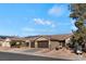 Tan two-story house with dark brown garage doors and solar panels on the roof at 1120 Casady Hollow Ave, Henderson, NV 89012