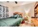 Interior bedroom view with a queen bed, dresser, and decorative lamps at 1134 Paradise Garden Dr, Henderson, NV 89002