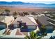 Aerial view of a single-story home featuring desert landscaping, a paver walkway, and a 2-car garage with mountain views at 1428 Chaparral Dr, Mesquite, NV 89027