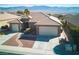 Well-maintained home featuring desert landscaping, a paver walkway, and a 2-car garage with mountain views at 1428 Chaparral Dr, Mesquite, NV 89027