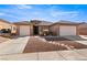 Charming single-story home featuring desert landscaping, a paver walkway, and a 2-car garage at 1428 Chaparral Dr, Mesquite, NV 89027