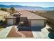 Well-maintained home featuring desert landscaping, a paver walkway, and a 2-car garage with mountain views at 1428 Chaparral Dr, Mesquite, NV 89027
