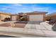 Well-maintained home featuring desert landscaping, a paver walkway, and a 2-car garage at 1428 Chaparral Dr, Mesquite, NV 89027