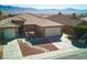 Well-maintained home featuring desert landscaping, a paver walkway, and a 2-car garage with mountain views at 1428 Chaparral Dr, Mesquite, NV 89027