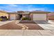 Charming single-story home featuring desert landscaping, a paver walkway, and a 2-car garage at 1428 Chaparral Dr, Mesquite, NV 89027