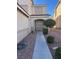 Inviting front entrance with a well-maintained walkway and beautiful landscaping at 1733 Gentle Brook St, North Las Vegas, NV 89084