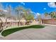 Spacious backyard with concrete patio, lush artificial turf, and privacy fencing at 190 Mount Saint Helens Dr, Henderson, NV 89012