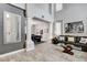 Open-concept living room features modern flooring, decorative columns, and a pool table in the background at 190 Mount Saint Helens Dr, Henderson, NV 89012