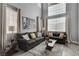 Bright living room has contemporary sofas, neutral paint and large windows at 190 Mount Saint Helens Dr, Henderson, NV 89012