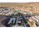 Neighborhood aerial view of a community with well-manicured landscaping, pools, and beautiful desert terrain at 1945 Canyon Highlands Dr, Henderson, NV 89052