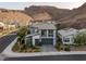 Aerial view of a modern, two-story home with desert landscaping in a community near the mountains at 1945 Canyon Highlands Dr, Henderson, NV 89052