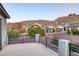 Back patio with mountain views and rod iron railing at 1945 Canyon Highlands Dr, Henderson, NV 89052