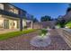 Beautiful backyard featuring low-maintenance landscaping, synthetic grass, and a covered patio at 1945 Canyon Highlands Dr, Henderson, NV 89052