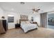 Bright, spacious bedroom with a ceiling fan, carpet and a sliding glass door at 1945 Canyon Highlands Dr, Henderson, NV 89052