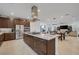 Open concept kitchen with granite island, stainless steel appliances, and dark wood cabinetry with an open layout at 1945 Canyon Highlands Dr, Henderson, NV 89052