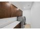 Functional laundry room with sleek washer and dryer, ample cabinet space, and a clean, modern design at 1945 Canyon Highlands Dr, Henderson, NV 89052