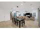 Open living space including dining area and living room with neutral tones, large window, and staircase at 1945 Canyon Highlands Dr, Henderson, NV 89052