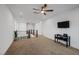 Spacious living room with plush carpeting, ceiling fan, and natural lighting at 1945 Canyon Highlands Dr, Henderson, NV 89052