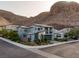 Street view showcasing a contemporary two-story home with desert landscaping near mountains at 1945 Canyon Highlands Dr, Henderson, NV 89052