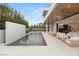 Backyard with a pool, fountain features, luxurious outdoor seating, and a modern architectural design at 21 Grey Owl Ct, Las Vegas, NV 89135