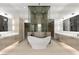 Luxurious bathroom featuring a freestanding tub, dual vanities, and a glass-enclosed shower with decorative tile at 21 Grey Owl Ct, Las Vegas, NV 89135