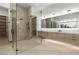 Modern bathroom with glass-enclosed shower, sleek vanities, and elegant mirrors for a spa-like experience at 21 Grey Owl Ct, Las Vegas, NV 89135