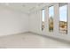Bright, empty room features sleek tile floors, three modern-style windows, and ample natural light at 21 Grey Owl Ct, Las Vegas, NV 89135