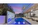 Gorgeous outdoor living space with a pool, water feature, and a sleek, modern architectural design at 21 Grey Owl Ct, Las Vegas, NV 89135