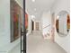 Modern foyer featuring neutral walls, modern art and unique mirror, with tiled floors and access to the staircase at 21 Grey Owl Ct, Las Vegas, NV 89135