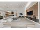 Expansive living room with fireplace and media wall, seamlessly flowing into the kitchen and dining area at 21 Grey Owl Ct, Las Vegas, NV 89135