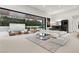 Bright open living room with large sectional, wet bar and seamless indoor outdoor living at 21 Grey Owl Ct, Las Vegas, NV 89135