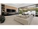 Modern living room with open access to the backyard, featuring stylish furnishings and a cozy fireplace feature at 21 Grey Owl Ct, Las Vegas, NV 89135
