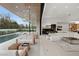 Bright open living room with large sectional and seamless flow to outdoor pool and patio at 21 Grey Owl Ct, Las Vegas, NV 89135