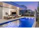 Modern outdoor space with a sleek pool, cozy fireplace, and stylish seating perfect for relaxation at 21 Grey Owl Ct, Las Vegas, NV 89135
