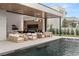Stunning outdoor space featuring a modern pool, fireplace and ample seating for entertaining at 21 Grey Owl Ct, Las Vegas, NV 89135