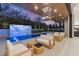 Elegant outdoor pool and seating area with lush landscaping and modern design features at 21 Grey Owl Ct, Las Vegas, NV 89135