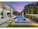 Backyard with a rectangular pool, stone patio, lush greenery, and a tranquil ambiance for outdoor relaxation at 21 Grey Owl Ct, Las Vegas, NV 89135